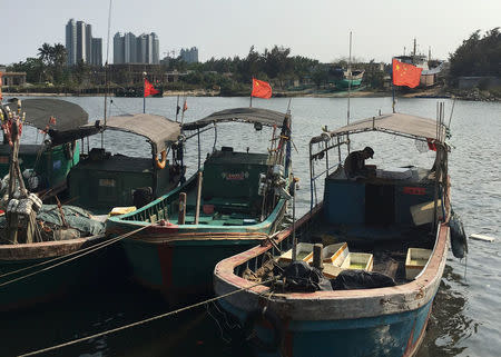 Fishing boats with Chinese national flags are seen at a harbour in Tanmen, Hainan province, April 5, 2016. REUTERS/Megha Rajagopalan