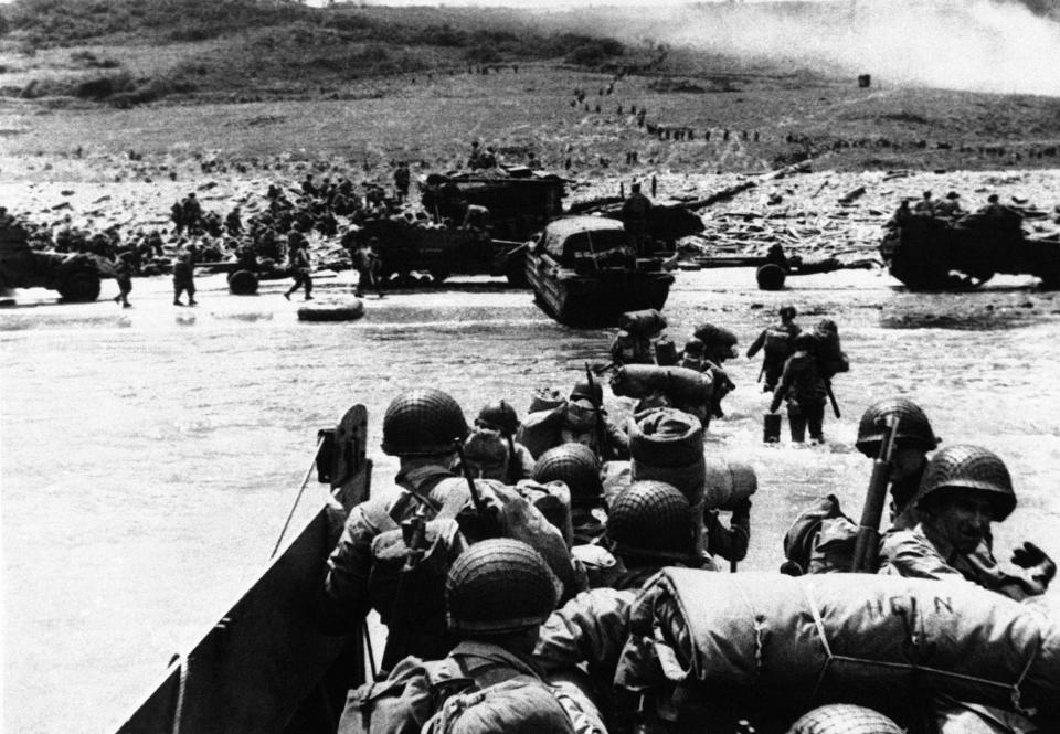 “Ducks” (amphibious trucks) and a half-track follow foot troops ashore during the invasion of France on a 100-mile front along the Normandy coast by Allied forces on June 6, 1944. (Photo: AP)