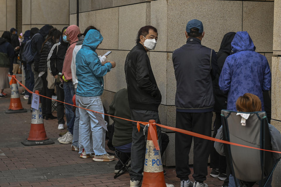 Members of the public wait in line to enter the West Kowloon Magistrates' Courts, where activist publisher Jimmy Lai's trial takes place, in Hong Kong, Tuesday, Jan. 2, 2024. (AP Photo/Billy H.C. Kwok)