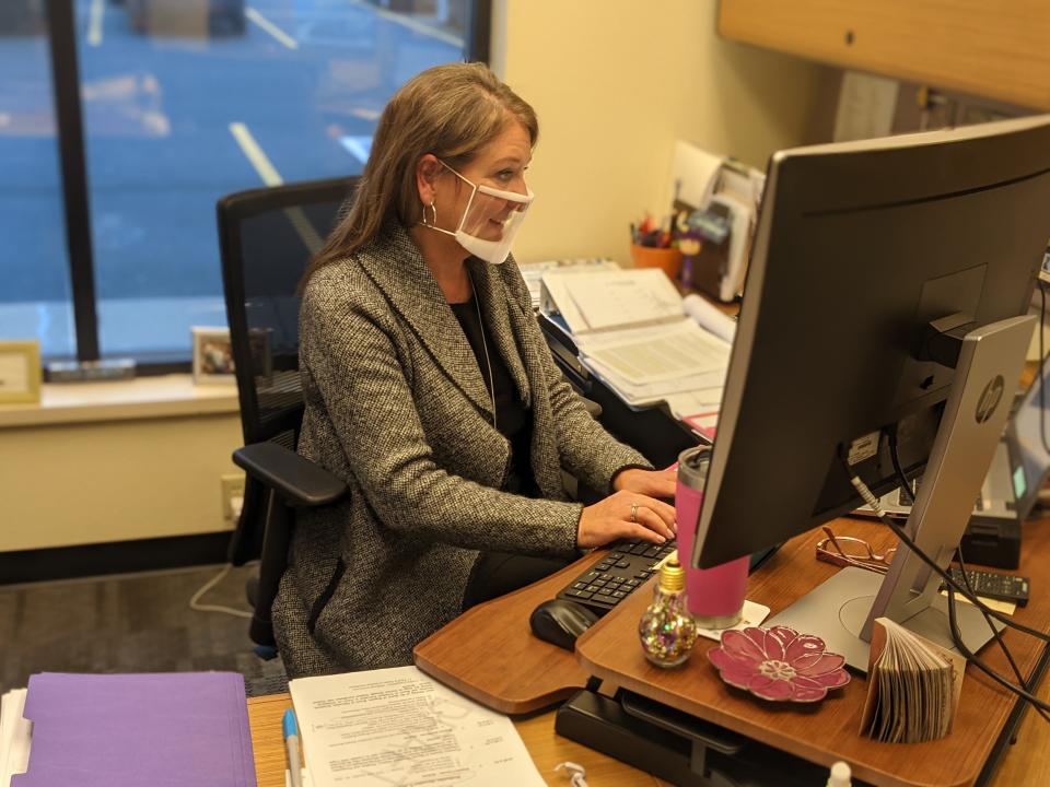 Superintendent Kim Wadsworth works at her desk while wearing a clear face mask Nov. 19, 2020, at the South Dakota School for the Deaf. She has been in the position since March, shortly after the coronavirus pandemic came to South Dakota.