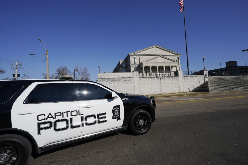 Capitol Police respond to a bomb threat at the Mississippi State Capitol and the Mississippi Supreme Court building, background,, Thursday morning, Jan. 4, 2024, in Jackson, Miss. The police were dealing with the second consecutive day of threats. (AP Photo/Rogelio V. Solis)