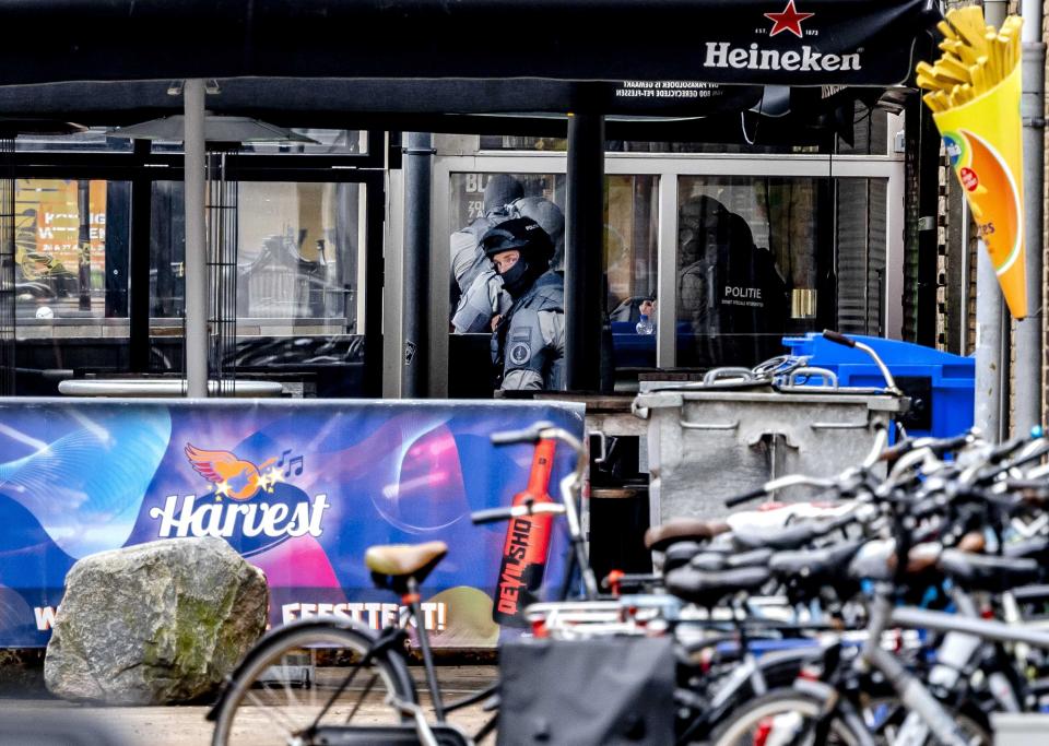 A member of a special unit of the police looks outside the Cafe Petticoat nightclub (EPA)