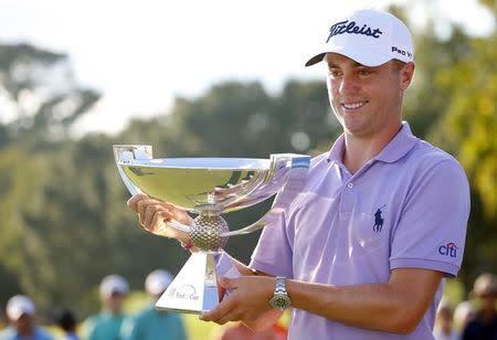 Sep 24, 2017; Atlanta, GA, USA; Justin Thomas hoists the trophy after winning the FedEx Cup following the Tour Championship golf tournament at East Lake Golf Club. Mandatory Credit: Butch Dill-USA TODAY Sports