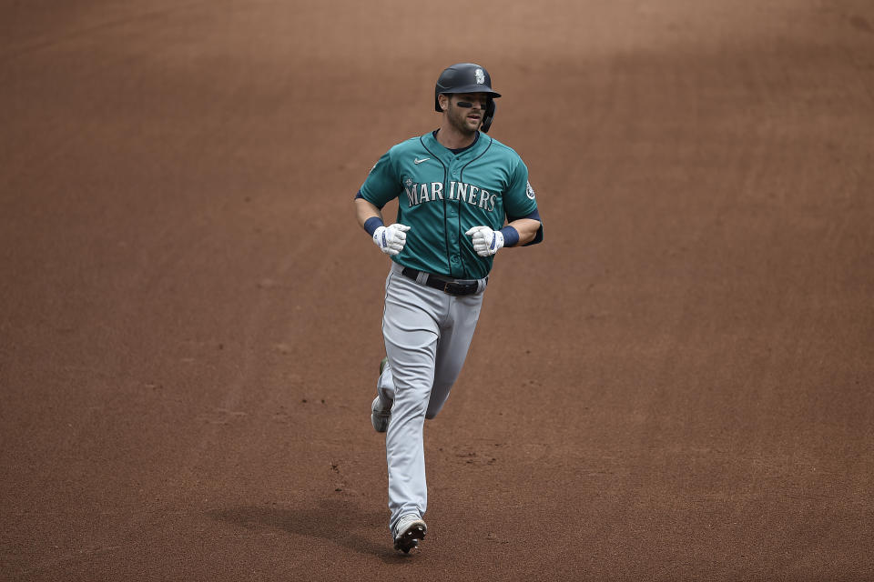 Seattle Mariners' Mitch Haniger rounds third base after hitting a two run home run against the Baltimore Orioles in the fifth inning of the first game of a baseball doubleheader, Thursday, April 15, 2021, in Baltimore. (AP Photo/Gail Burton)
