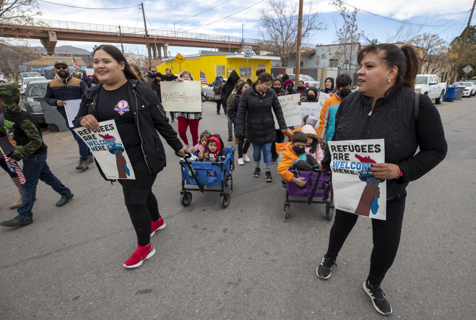 Residents march in support of migrants in downtown El Paso, Texas, Saturday, Jan. 7, 2023. Several hundred marched through the streets of El Paso a day before President Joe Biden's first, politically-thorny visit to the southern border. (AP Photo/Andres Leighton)