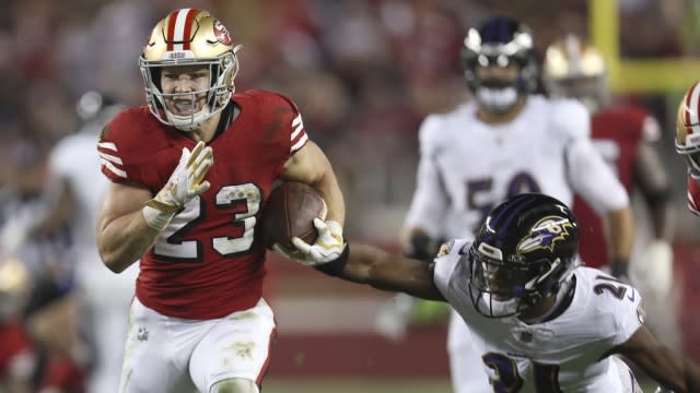 San Francisco 49ers running back Christian McCaffrey (23) runs against Baltimore Ravens cornerback Brandon Stephens (21).