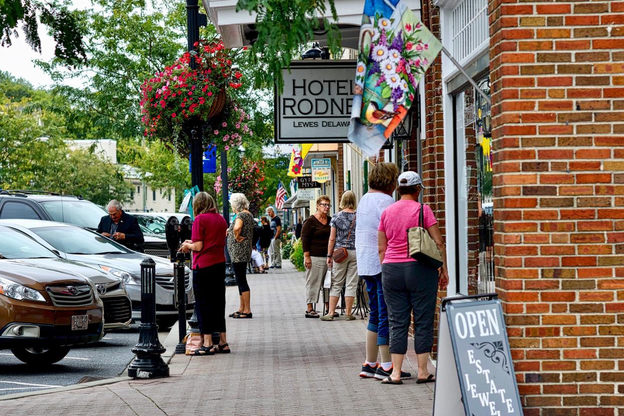 tourists enjoy a Fall afternoon walking through Lewes' main downtown historic district