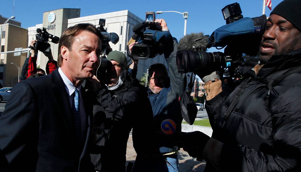 Former Senator John Edwards wades through a crowd of media as he enters the Greensboro Federal Courthouse Thursday, April 12, 2012. It is the first day of jury selection for his trial on conspiring to violate campaign finance laws and accepting illegal contributions during his campaign for President.