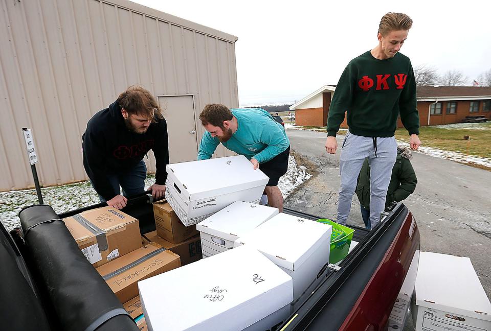 Ashland University students and members of Phi Kappa Psi fraternity freshman Brendan Dee, senior Ryan Ortner and junior Ethan Wolford load boxes from the Ashland Parenting Plus offices in the Ashland County Service Center into the back of a pickup as they help move them to new offices on Sandusky Street. Student participated in AU GIVS (Ashland University Gets Involved with Volunteer Service) on Monday.
