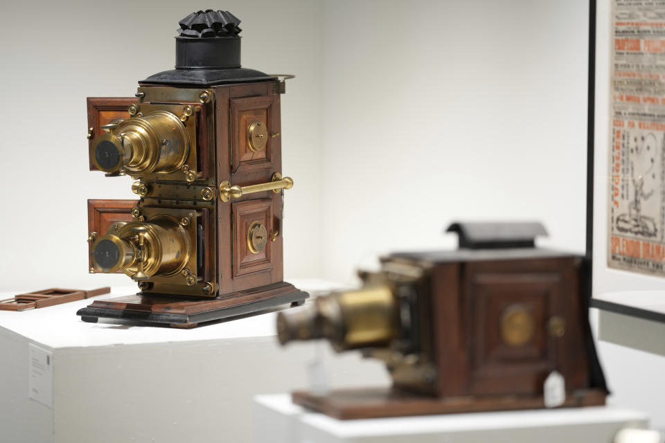 Magic lantern projectors, from the Ricky Jay Collection, are displayed at Sotheby's on Friday, Oct. 22, 2021, in New York. The widow of the sleight-of-hand artist, card shark, author, actor and scholar turned over nearly 2,000 curiosities Jay collected to Sotheby's for an unusual auction. Divided into 634 lots, it's the focus of a live auction Wednesday and Thursday. (Photo by Charles Sykes/Invision/AP)