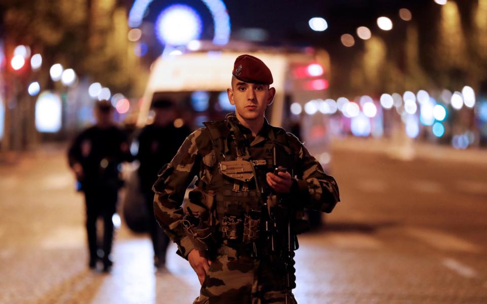 A French soldier stands guard during ongoing police operations - Credit: EPA