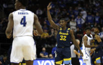 Marquette guard Darryl Morsell (32) reacts after a 3-point shot against Seton Hall during the first half of an NCAA college basketball game in Newark, N.J., Wednesday, Jan. 26, 2022. (AP Photo/Noah K. Murray)