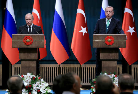 Turkish President Tayyip Erdogan and Russian counterpart Vladimir Putin attend a news conference in Ankara, Turkey, December 11, 2017. Murat Cetinmuhurdar/Presidential Palace/Handout via REUTERS