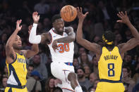 New York Knicks forward Julius Randle (30) moves the ball around Indiana Pacers forwards Justin Holiday (8) and T.J. Warren (1) in the first half of an NBA basketball game, Friday, Feb. 21, 2020, at Madison Square Garden in New York. (AP Photo/Mary Altaffer)