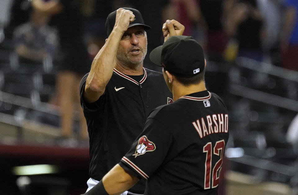 Arizona Diamondbacks manager Torey Lovullo gives a fist bump to Daulton Varsho after their 5-2 win over the San Francisco Giants at the end of a baseball game, Saturday Sept. 24, 2022, in Phoenix. (AP Photo/Darryl Webb)