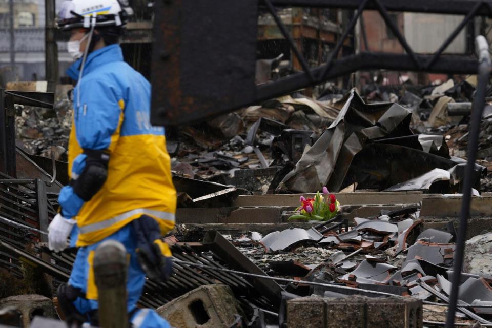 Tulips are offered at a burnt-out house in Wajima, Ishikawa prefecture, Japan on Sunday (Kyodo News via AP)