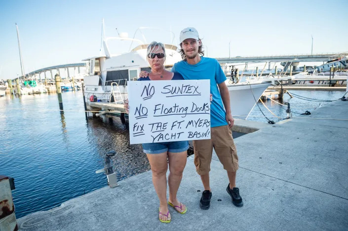 Lora Brooks, left, is a liveaboard at the Fort Myers Yacht Basin and does not want to leave despite the city claiming the marina is severely damaged and uninhabitable on Friday, Oct. 7, 2022.