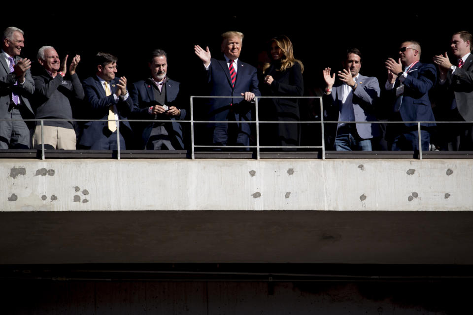 President Donald Trump and first lady Melania Trump wave during a NCAA college football game between LSU and Alabama at Bryant-Denny Stadium, in Tuscaloosa, Ala., Saturday, Nov. 9, 2019. (AP Photo/Andrew Harnik)