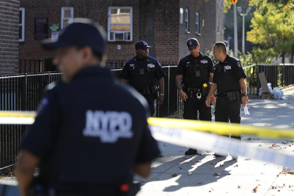 Emergency personnel work near the scene of a fatal shooting of a police officer in the Bronx borough of New York, Sunday, Sept. 29, 2019. (AP Photo/Seth Wenig)