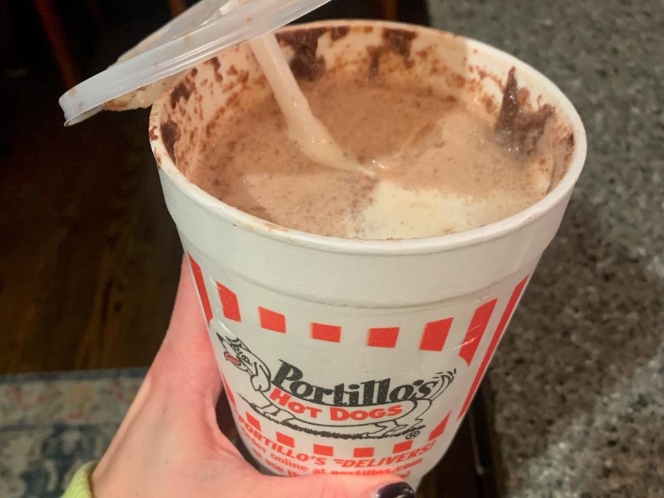 hand holding up a portillos chocolate cake shake