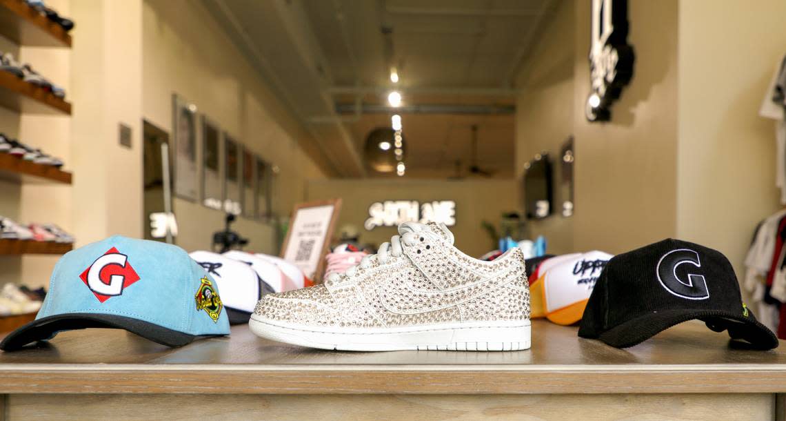 The Cactus Plant Flea Market x Swarovski x Dunk Low ‘Pure Platinum’ on display at Sixth Ave at 482 First St. in downtown Macon. Two of the three owners have a pair of these shoes valued unworn at $3,000.