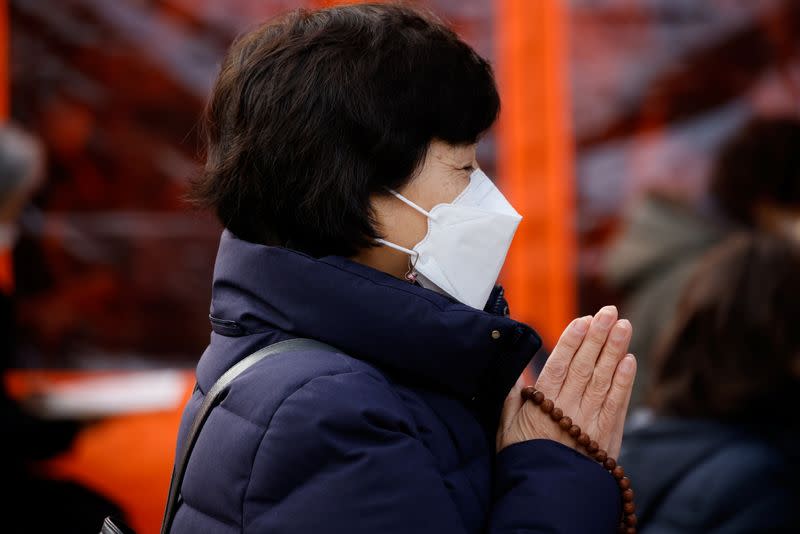 A mother prays for children’s success in the college entrance examinations amid the coronavirus disease (COVID-19) pandemic, at a Buddhist temple in Seoul