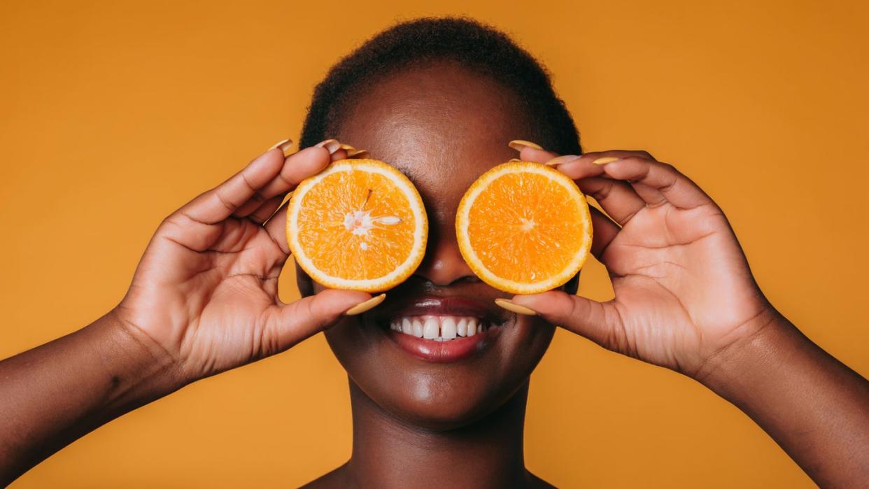 a man holding oranges