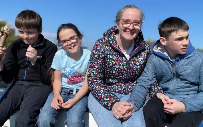 Oran (right) with his mum Justine and his two siblings