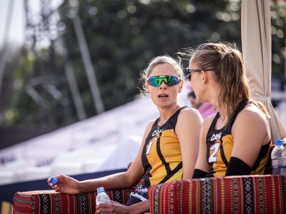 Canada's Sarah Pavan, left, and Sophie Bukovec, right, look at each other Friday during a pair of losses at the beach volleyball Pro Tour Finals on Friday in Doha, Qatar. (Volleyball World - image credit)