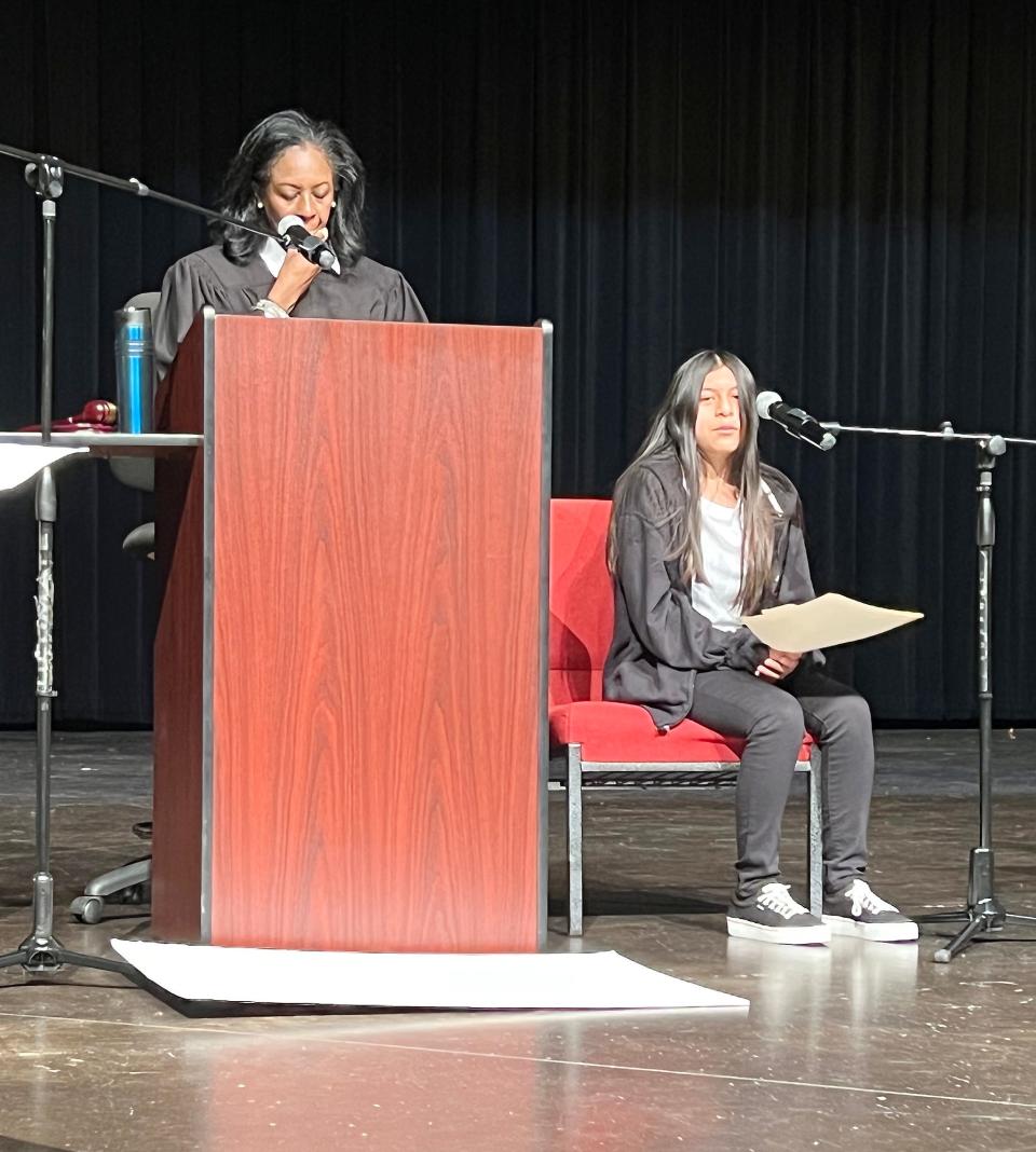 "Defendant" Lesly Ramos of Litchfield Middle School testifies during a mock trial Friday in Gadsden City High School's auditorium. At the podium is Gadsden Municipal Judge Nikki Tinker, who presided over the event that involved the city's three middle schools.