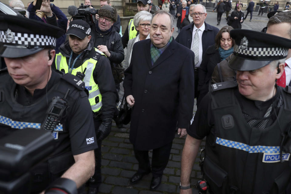 Former Scottish leader Alex Salmond, center, leaves the High Court in Edinburgh, Thursday Nov. 21, 2019. Salmond, one of the country's best-known politicians, appeared in court faces a total of 14 charges of attempted rape, sexual assault and indecent assault against 10 women. (Andrew Milligan/PA via AP)