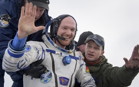 Alexander Gerst is helped out of the Soyuz MS-09 spacecraft just minutes after landing in Zhezkazgan, Kazakhstan - Credit: Getty