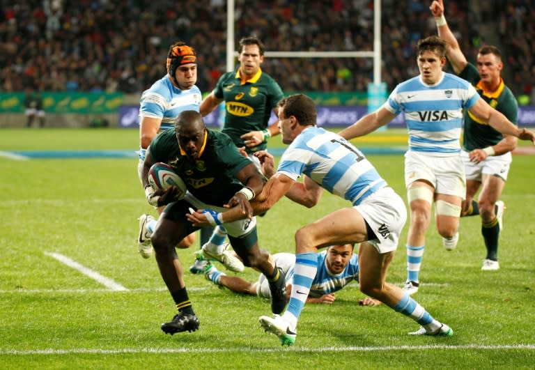 Springboks winger Raymond Rhule (L) breaks through the Argentinian defence during the International Rugby Championship Test match August 19, 2017