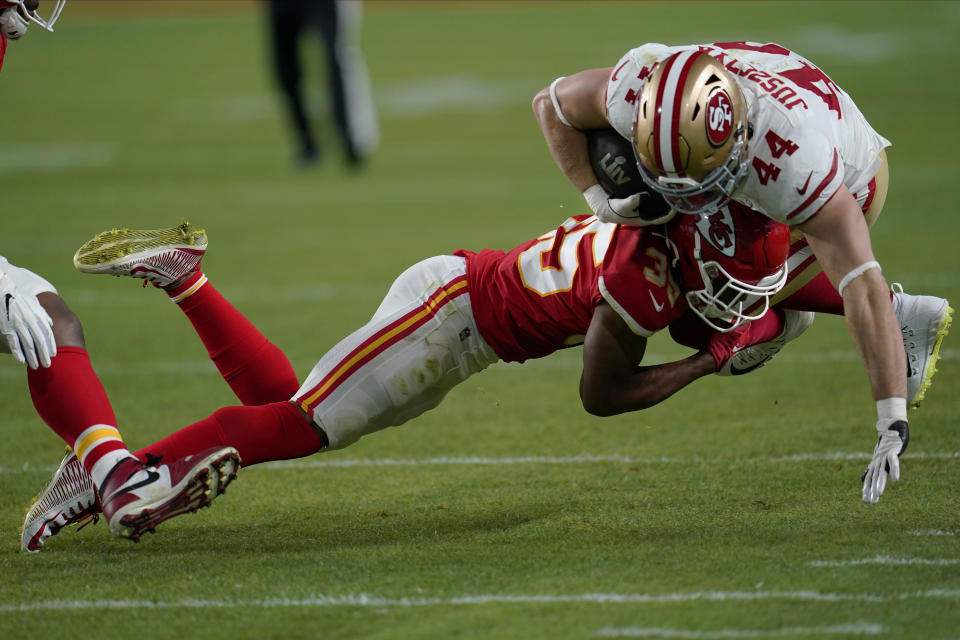 Kansas City Chiefs defensive back Charvarius Ward tackles San Francisco 49ers fullback Kyle Juszczyk during the second half of Super Bowl LIV. (AP Photo/David J. Phillip)