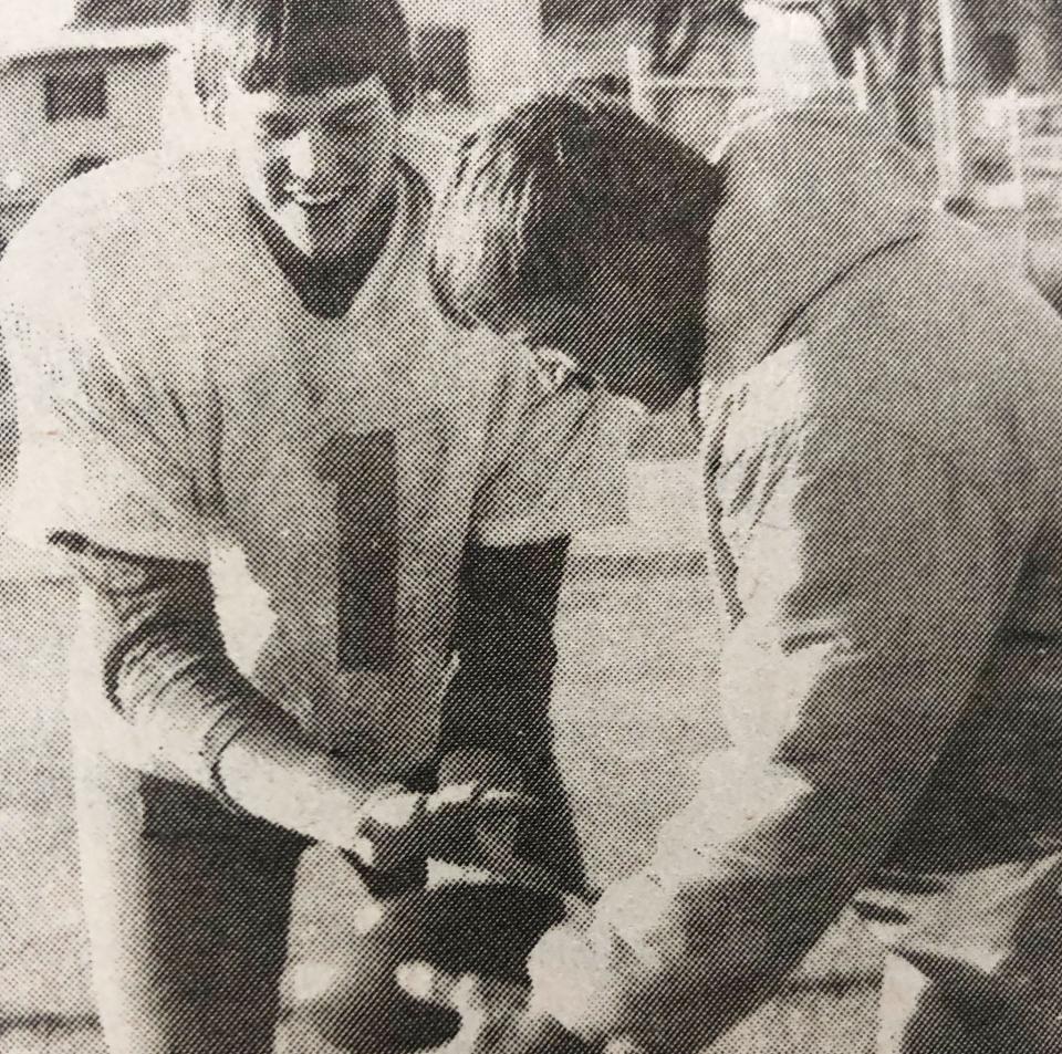 Hamlin High School quarterback Bryon Noem takes a handoff from assistant coach Bob Gill in the mid-1980s. Noem later went on to play quarterback at Northern State.