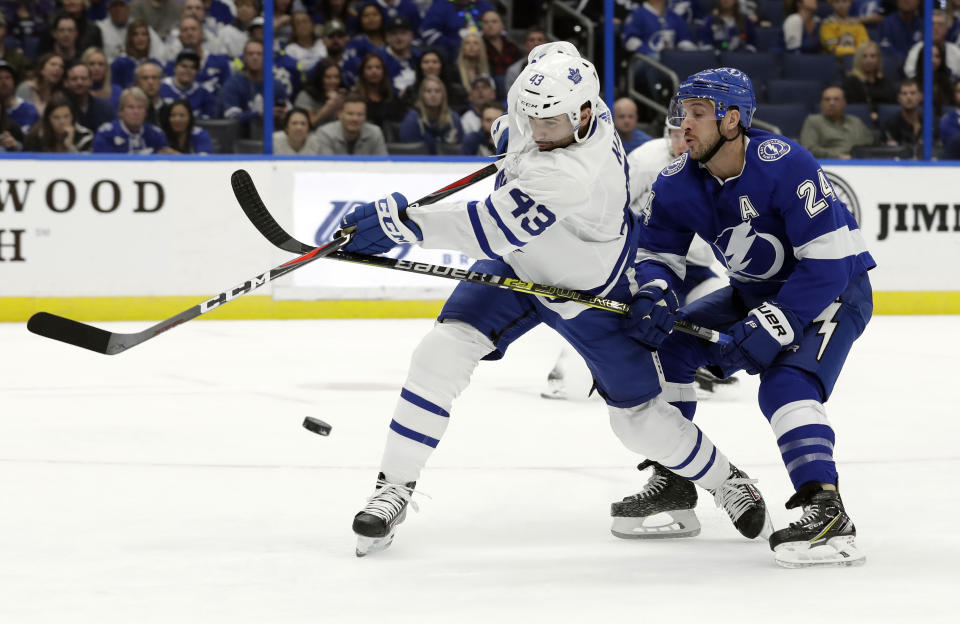 Tampa Bay Lightning right wing Ryan Callahan (24) blocks a shot by Toronto Maple Leafs center Nazem Kadri (43) during the first period of an NHL hockey game Thursday, Dec. 13, 2018, in Tampa, Fla. (AP Photo/Chris O'Meara)