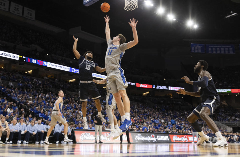 Georgetown's Jayden Epps (10) shoots against Creighton's Ryan Kalkbrenner (11) during the first half of an NCAA college basketball game, Tuesday, Feb. 13, 2024, in Omaha, Neb. (AP Photo/Rebecca S. Gratz)