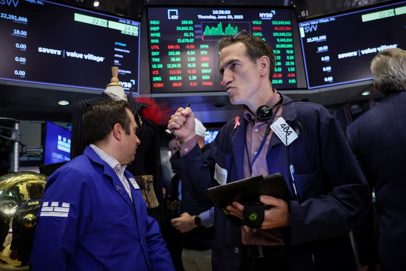 Traders work on the floor of the NYSE in New York