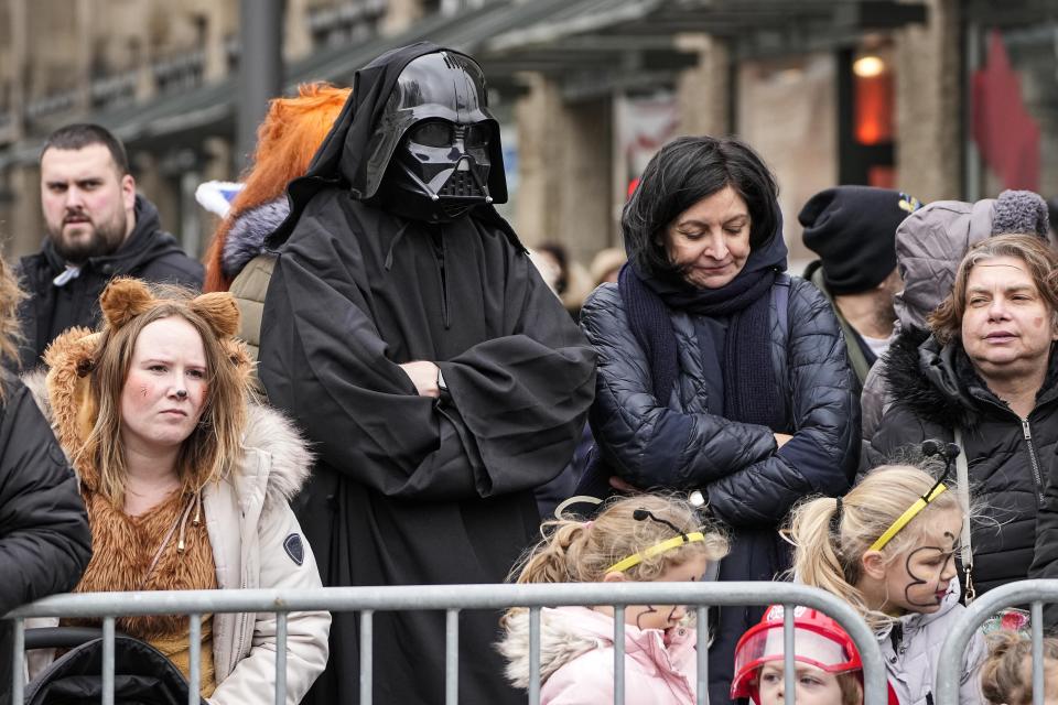 Revellers wait for the traditional carnival parade in Duesseldorf, Germany, on Monday, Feb. 20, 2023. The foolish street spectacles in the carnival centers of Duesseldorf, Mainz and Cologne, watched by hundreds of thousands of people, are the highlights in Germany's carnival season on Rosemonday. (AP Photo/Martin Meissner)