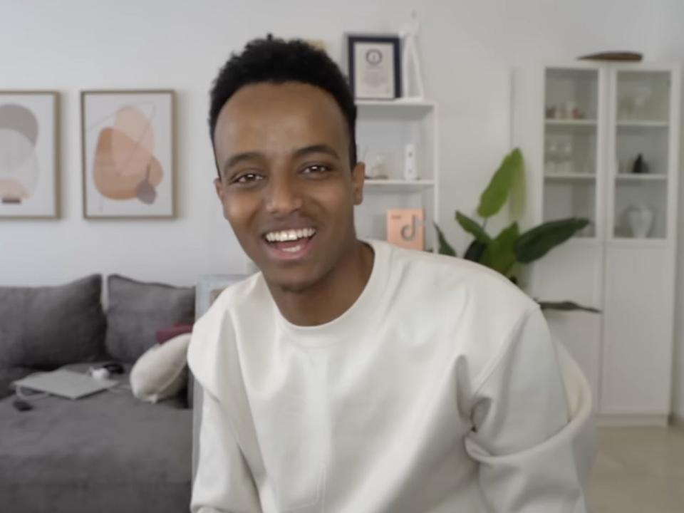 Screenshot from a recent AboFlah YouTube video, smiling in his living room.