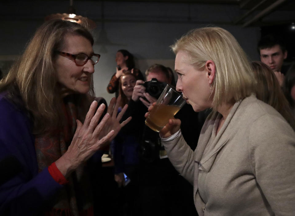 Potential Democratic presidential candidate Sen. Kirsten Gillibrand, D-NY, right, listens to Jan Pendlebury of Goffstown, N.H. during an event organized by the Young Democrats of New Hampshire at Stark Brewing Co., Friday, Feb. 1, 2019, in Manchester, N.H. Gillibrand is making her first trip to New Hampshire as a presidential prospect. (AP Photo/Elise Amendola)