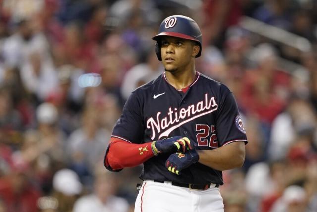 Washington Nationals' Juan Soto, front, stands in the dugout