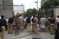 KARACHI, PAKISTAN - JUNE 29: Police officers inspect the site after gunmen attacked the Pakistani stock exchange building in Karachi, Pakistan on June 29, 2020. At least nine people were killed. The dead include four attackers, four Pakistan Stock Exchange security guards and a policeman, Muqaddas Haider, a city police chief, told reporters. At least seven people are also injured. (Photo by Sabir Mazhar/Anadolu Agency via Getty Images)