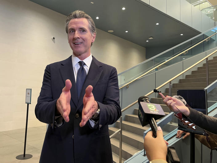 California Gov. Gavin Newsom talks to reporters in Sacramento, Calif., Friday, Nov. 18, 2022. Newsom has agreed to release $1 billion in state homelessness funding he testily put on pause earlier in the month. But his office says he will do so only if local governments agree to step up the aggressiveness of their plans going forward to reduce homelessness. (AP Photo/Janie Har)