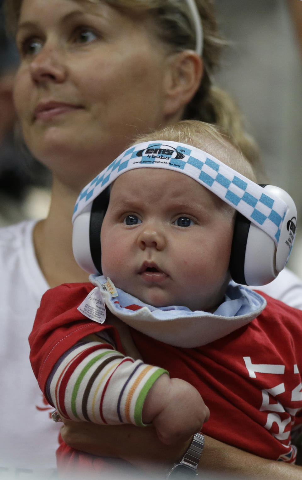 A mother watches with her baby the men's handball quarterfinal match between Iceland and Hungary at the 2012 Summer Olympics, Wednesday, Aug. 8, 2012, in London. (AP Photo/Matthias Schrader)