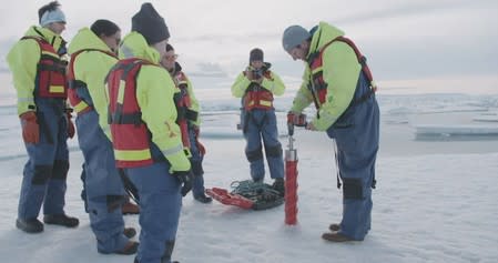 Chief Scientist for the U.S.-led Northwest Passage Project Dr. Brice Loose drills an ice core in the Canadian Arctic during an 18-day icebreaker expedition that took place in July and August 2019