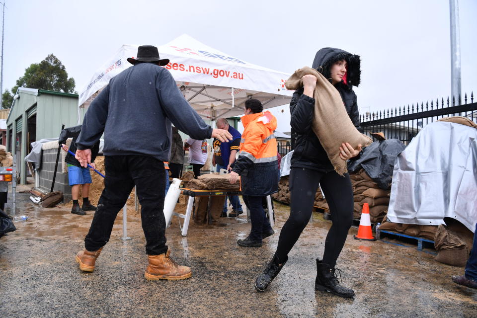 SES volunteers at Penrith SES making and providing free sandbags to residents on Saturday. Source: AAP