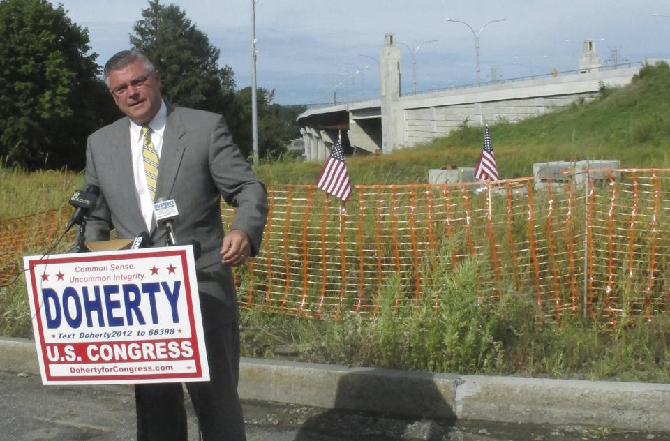 Republican 1st Congressional District candidate Brendan Doherty speaks to the media in Tiverton, R.I., Thursday, Sept. 6, 2012. Doherty said he wants the federal government to intervene to stop the state from imposing tolls on the new Sakonnet River Bridge, right rear. (AP Photo/Michelle R. Smith)