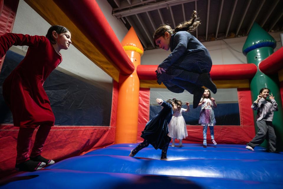 Children enjoy a bouncy castle during the Eid festival held Saturday at the Worcester Islamic Center.