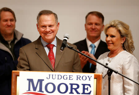 FILE PHOTO: Republican U.S. Senate candidate Roy Moore addresses supporters as his wife Kayla (R) looks on at his election night party in Montgomery, Alabama, U.S., December 12, 2017. REUTERS/Jonathan Bachman/File Photo